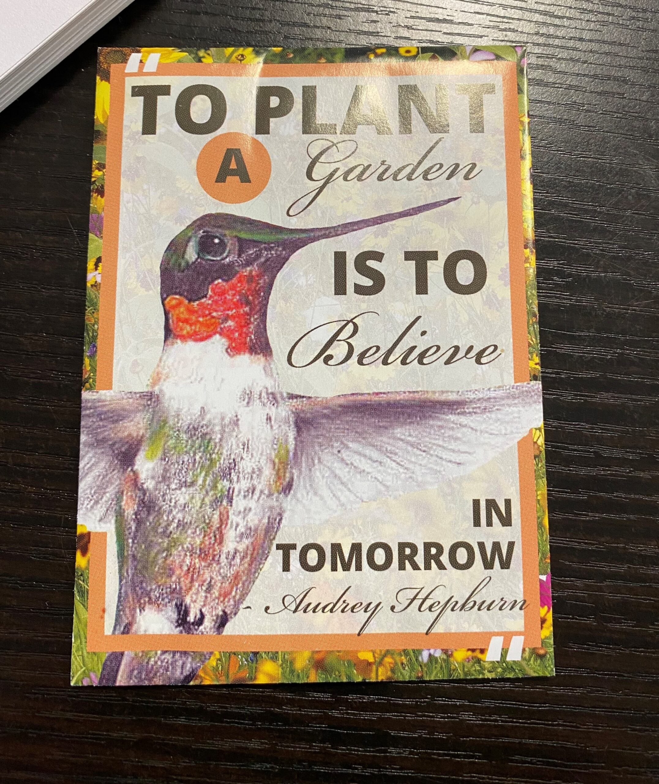 A colorful card with a hummingbird and the quote: 