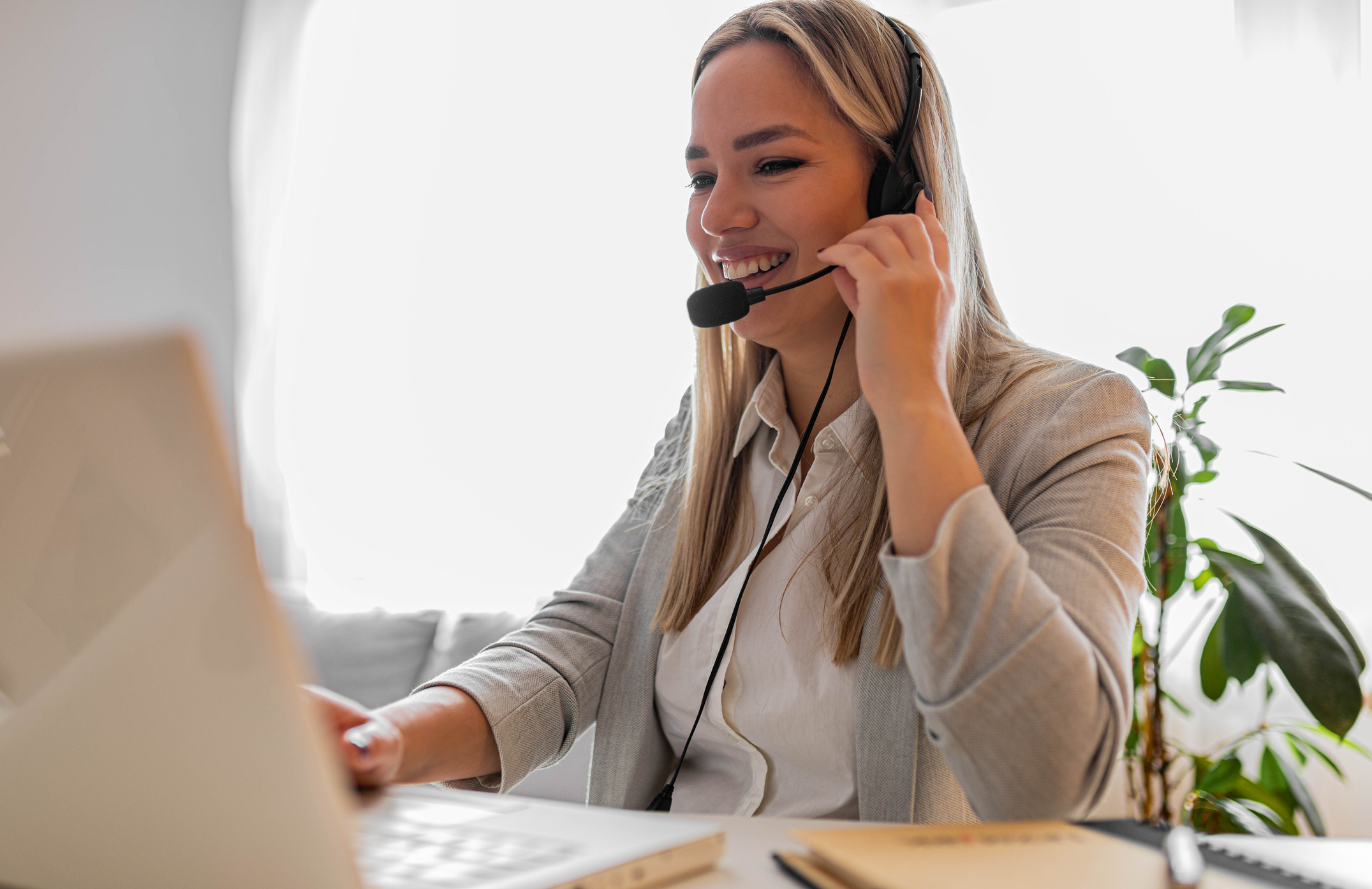Young woman working in call center. Customer support woman in office